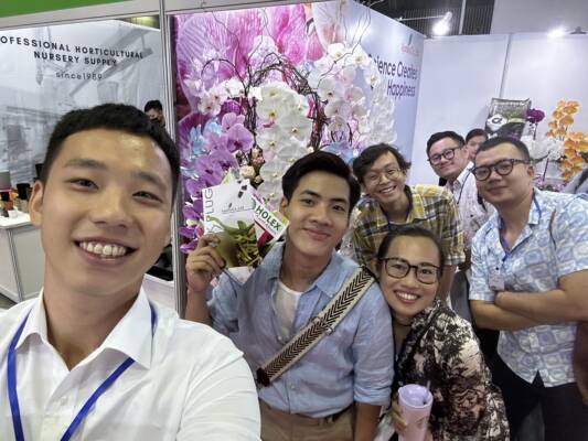 selfie picture of Robert Wang with the The Royal Base Corporation team posing at the TIOS orchid show.