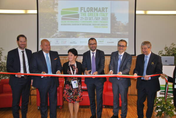 Delegates stand behind ribbon before opening of Flormart 2022
