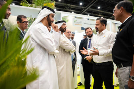 Government representatives and industry professionals in discussion at a stand during Myplant & Garden Middle East.