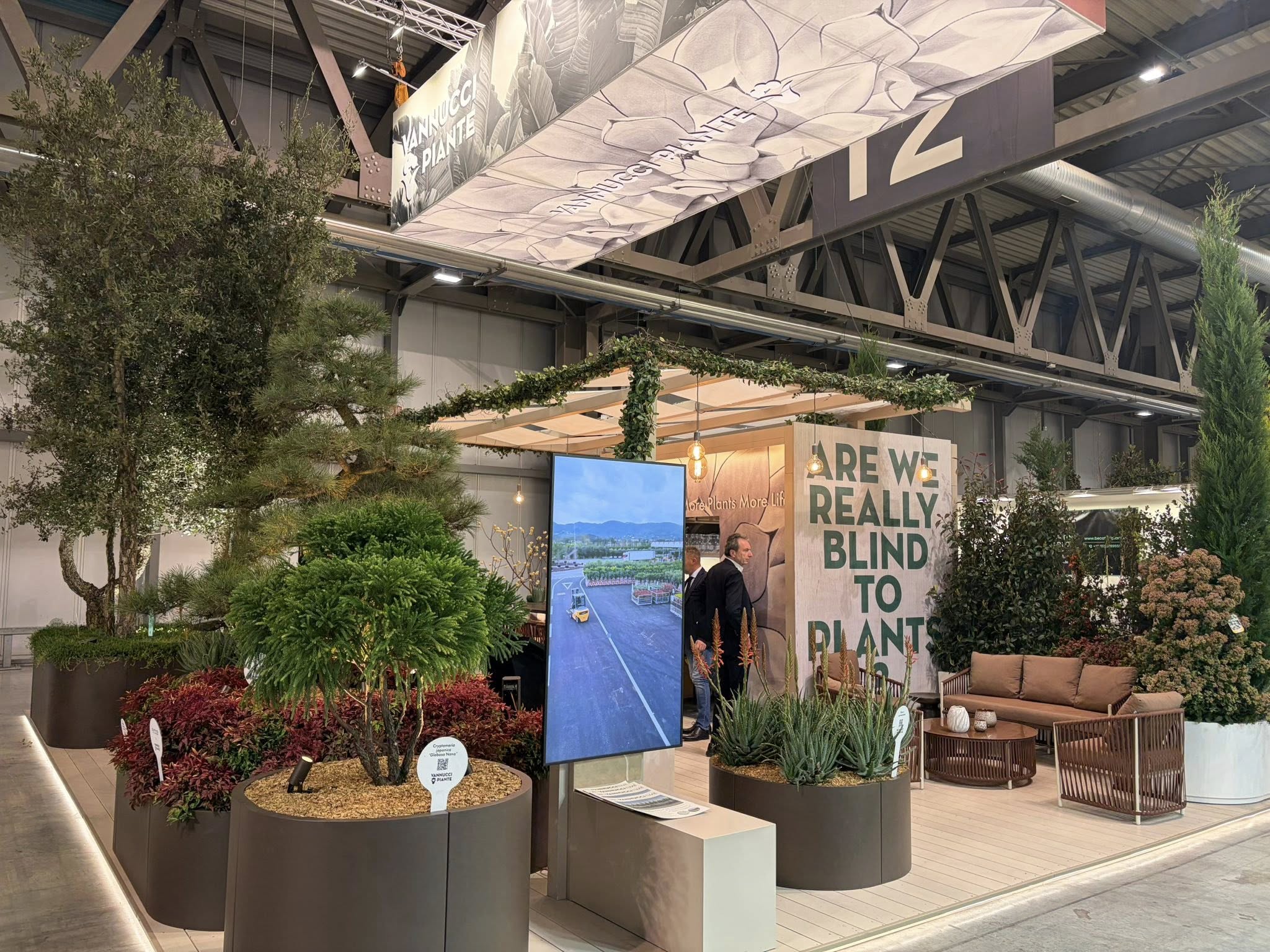 Exhibition stand displaying urban planting concept with “Are We Really Blind to Plants?” signage.
