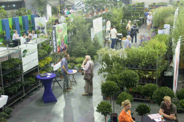 Professional visitors networking among ornamental plant stands at Florall trade fair in Waregem, Belgium.
