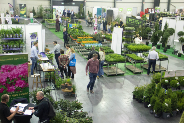 Trade visitors and growers networking among ornamental plant stands at Florall trade fair in Waregem, Belgium.