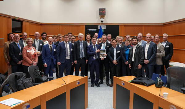 Group photo of ENA representatives and participants holding the manifesto at the European Parliament in Brussels.