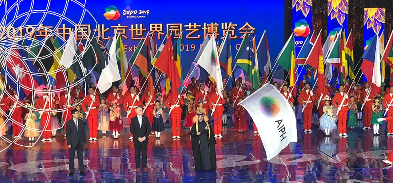 Man waving the AIPH flag in an exhibition