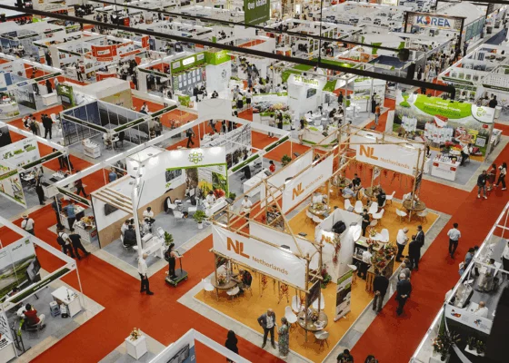 Overhead view of HortEx exhibition hall with international stands and visitor activity.