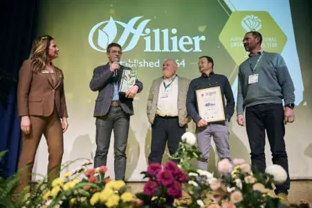 Adam Dunnett accepts the Gold Rose on stage at the AIPH International Grower of the Year Awards 2026 in Essen.