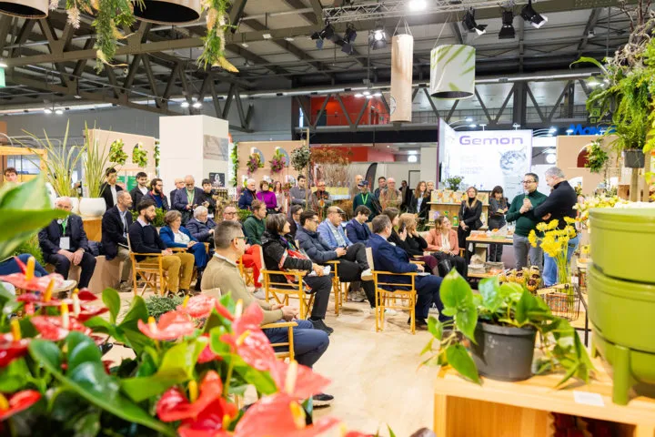 Audience attending seminar surrounded by plant displays at MyPlant & Garden.