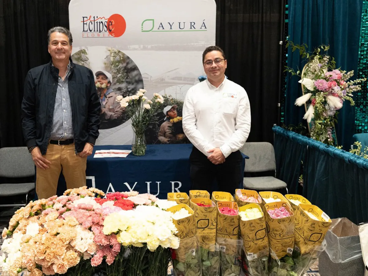 José Antonio Restrepo Rada at an AYURÁ and Eclipse Flowers trade stand displaying Colombian carnations.
