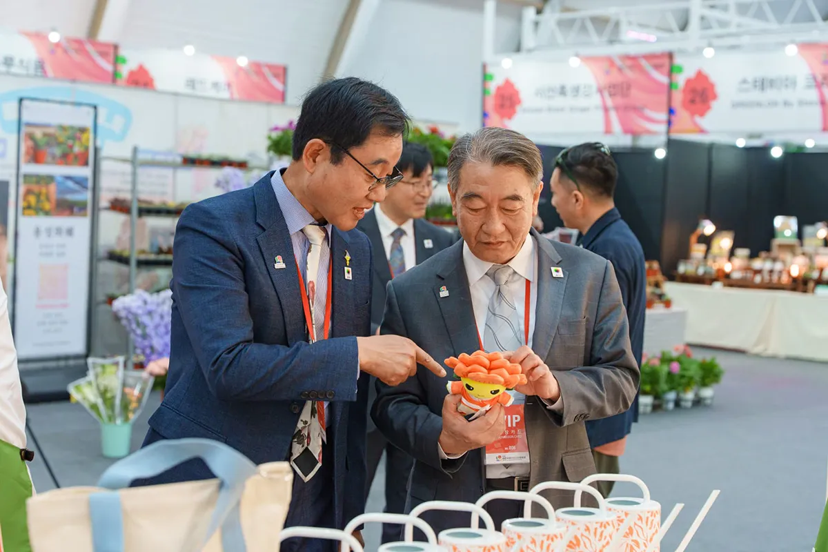 Visitors engaging with plant-themed merchandise at an exhibition stand during Taean Expo 2026