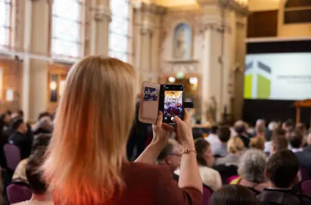 Audience member photographing presentation at Tuinbouw Footprint Event in the Netherlands