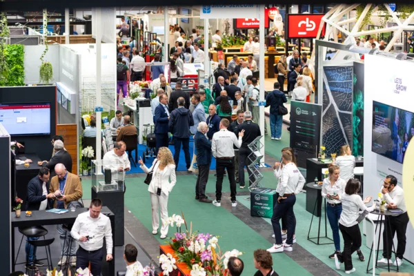 Busy GreenTech Amsterdam exhibition floor with visitors and technology stands.